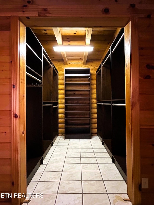 spacious closet with light tile patterned floors