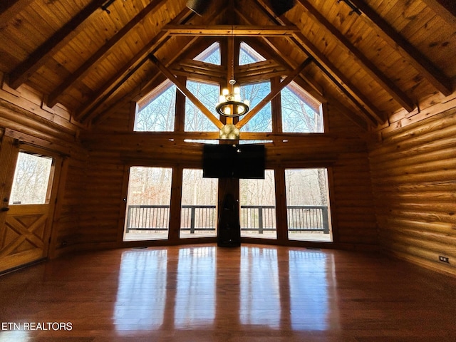 unfurnished living room with log walls, hardwood / wood-style floors, high vaulted ceiling, and beam ceiling