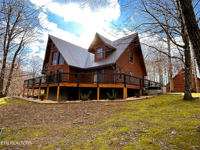 back of house featuring a yard and a wooden deck