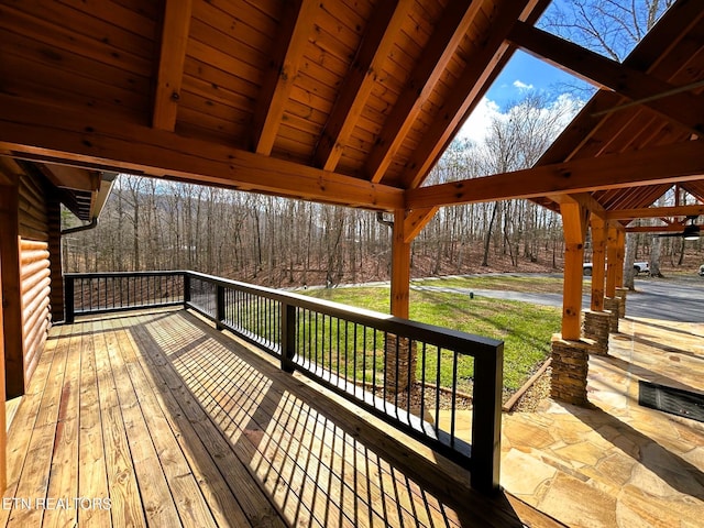 wooden terrace with a yard