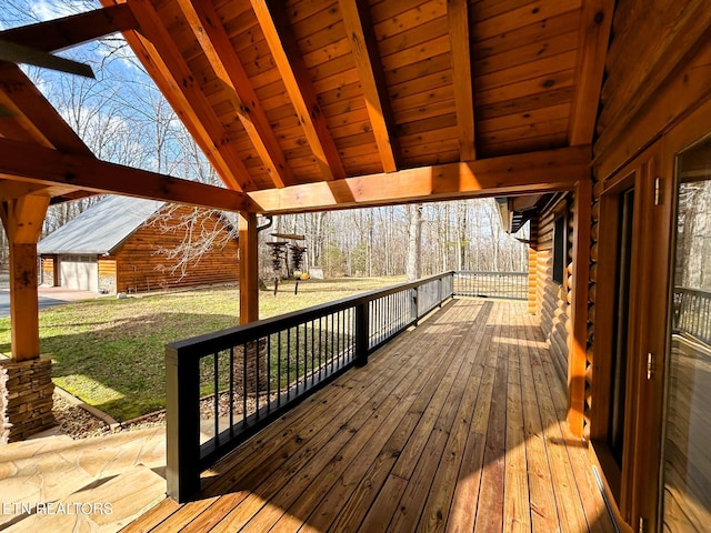 wooden deck featuring a yard