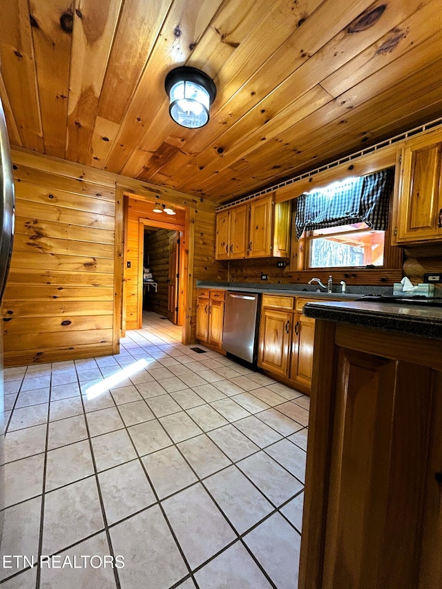 kitchen with dishwasher, sink, wooden walls, light tile patterned flooring, and wood ceiling