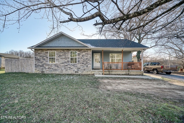 single story home featuring a porch and a front lawn