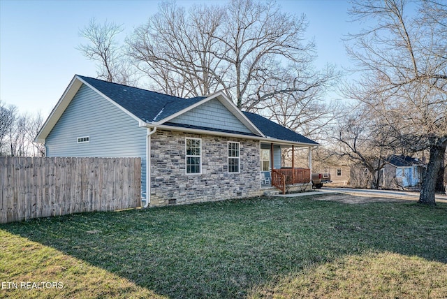 view of side of property with a porch and a lawn