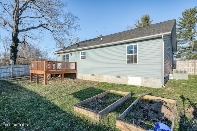 rear view of property featuring a yard, central air condition unit, and a wooden deck