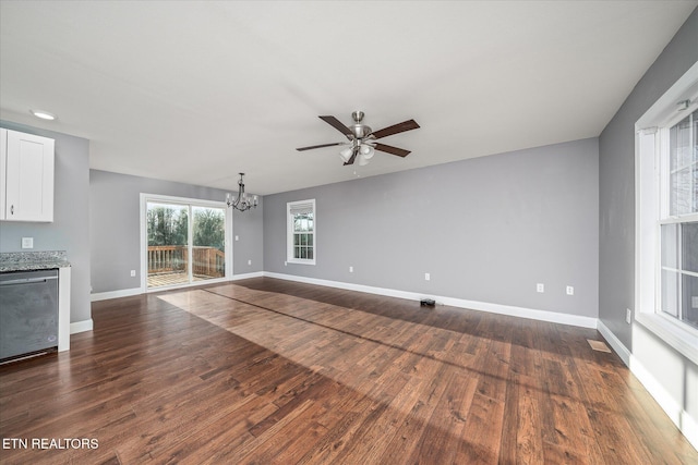 unfurnished living room featuring dark hardwood / wood-style floors and ceiling fan with notable chandelier