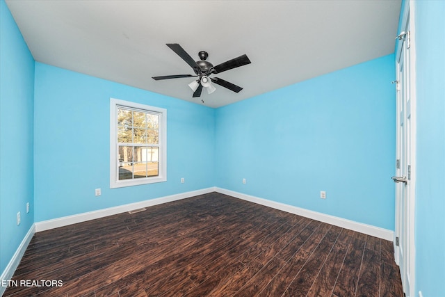 spare room featuring ceiling fan and dark wood-type flooring