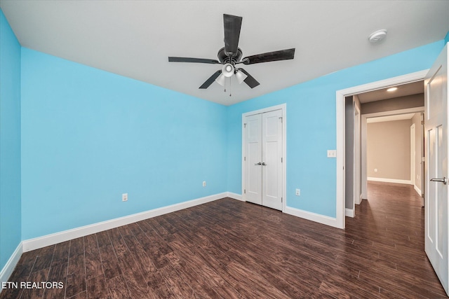 unfurnished bedroom featuring a closet, ceiling fan, and dark wood-type flooring