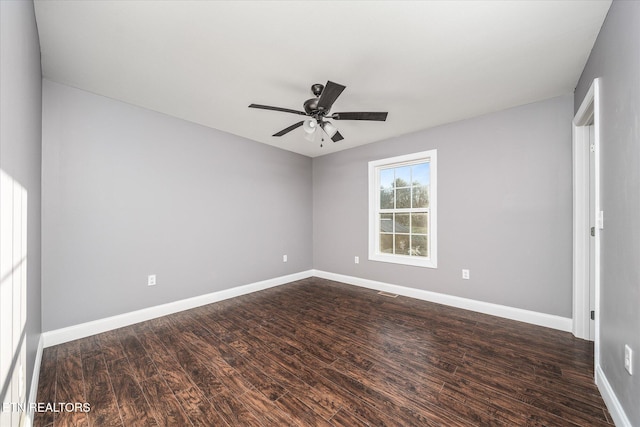 unfurnished room featuring ceiling fan and dark hardwood / wood-style flooring