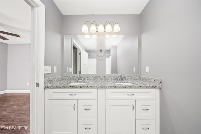 bathroom featuring hardwood / wood-style floors, ceiling fan, and vanity