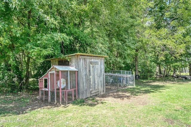 view of outdoor structure featuring a lawn