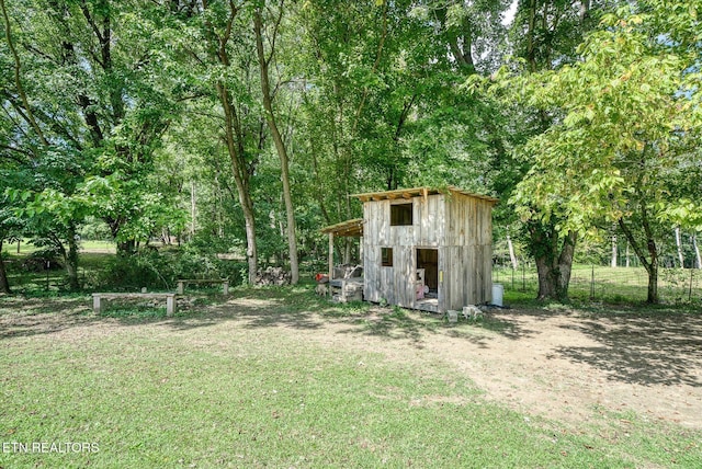 view of outbuilding featuring a lawn