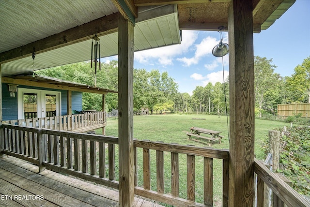 wooden terrace with a lawn