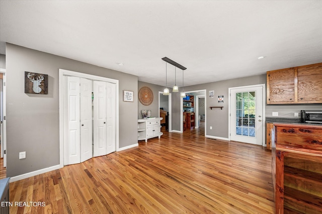 kitchen featuring light hardwood / wood-style flooring and hanging light fixtures