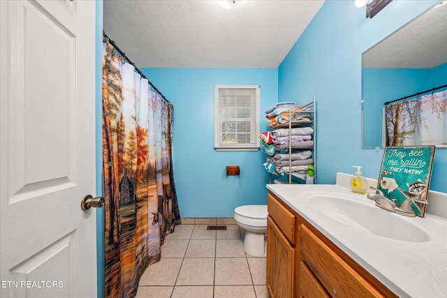 bathroom with tile patterned floors, vanity, toilet, and a textured ceiling