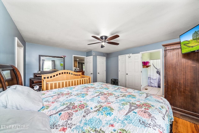 bedroom with ceiling fan, light hardwood / wood-style floors, and ensuite bathroom