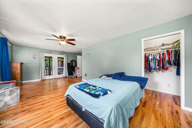 bedroom featuring access to exterior, french doors, ceiling fan, hardwood / wood-style flooring, and a closet