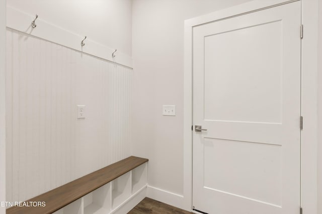 mudroom with dark wood-style floors and baseboards