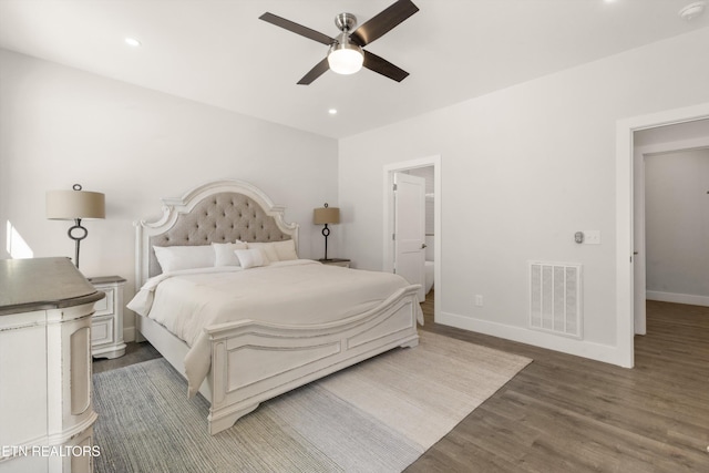 bedroom with ceiling fan, dark hardwood / wood-style flooring, and ensuite bath