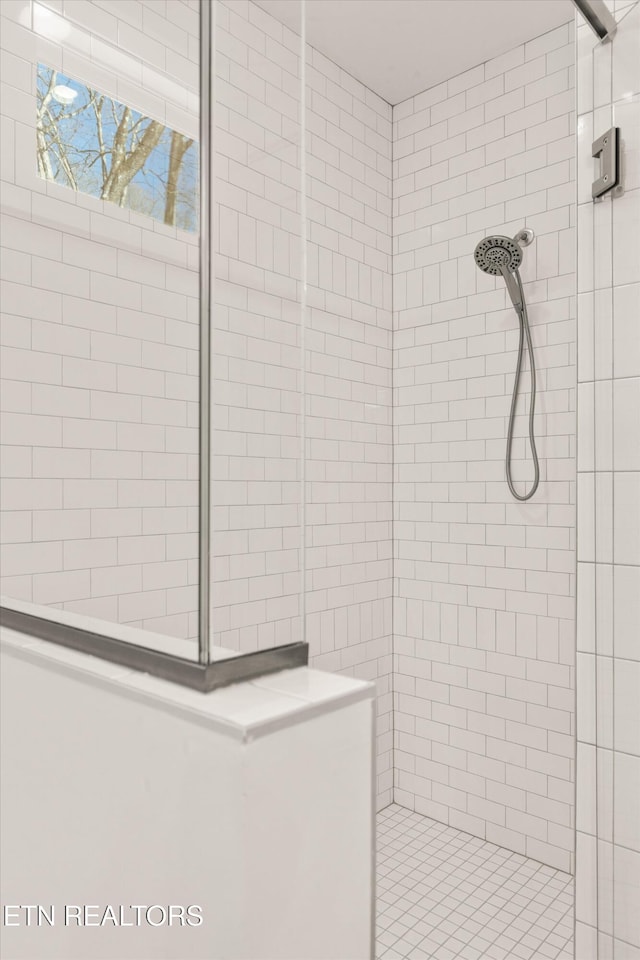 bathroom with a tile shower