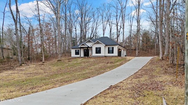 modern inspired farmhouse with a front lawn