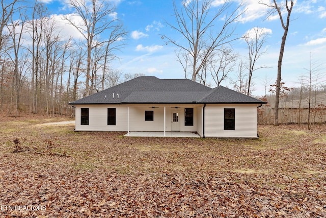 back of house featuring roof with shingles and a patio