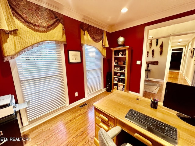 office space with wood-type flooring, plenty of natural light, and crown molding