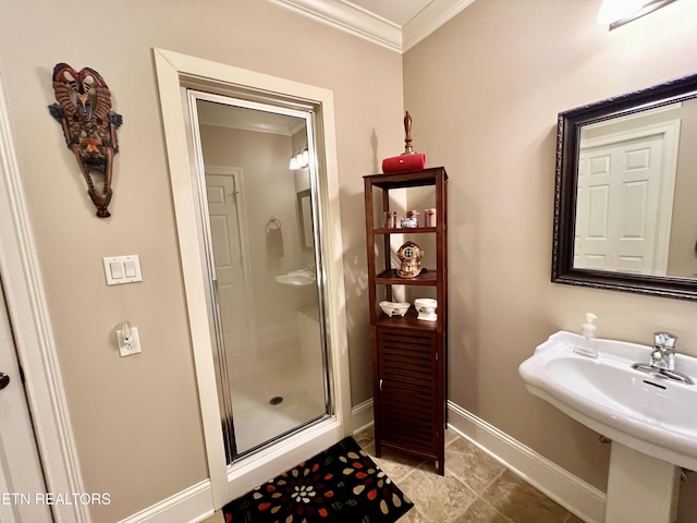 bathroom with sink, a shower with shower door, and crown molding