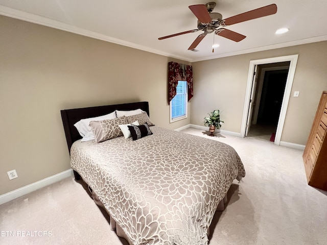 carpeted bedroom with ceiling fan and crown molding