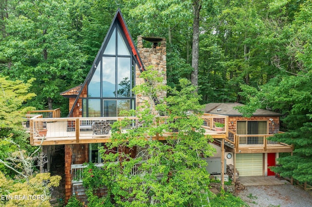 exterior space with a garage and a deck