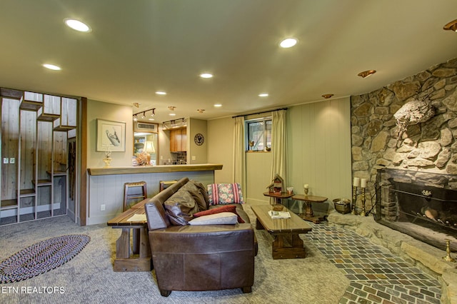 living room with a stone fireplace