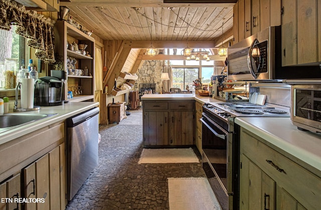 kitchen featuring appliances with stainless steel finishes, green cabinetry, wooden ceiling, a stone fireplace, and wood walls