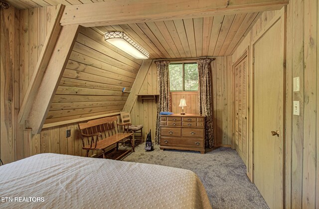 bedroom featuring wood walls, light colored carpet, and wooden ceiling