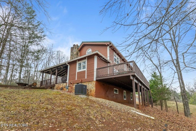 view of home's exterior featuring central AC unit and a wooden deck