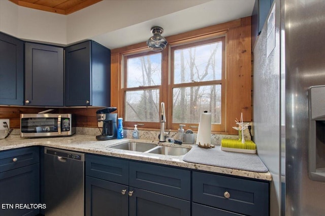 kitchen with blue cabinets, sink, appliances with stainless steel finishes, and wooden ceiling