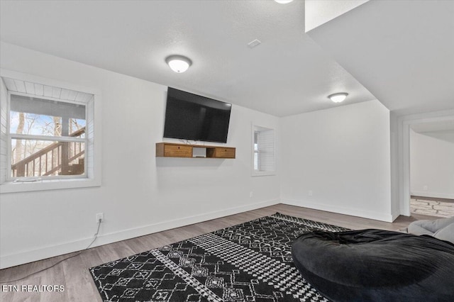 interior space featuring hardwood / wood-style flooring and a textured ceiling