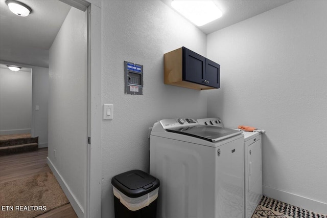 clothes washing area featuring washer and clothes dryer, cabinets, and carpet floors