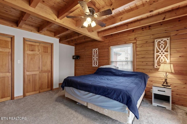 bedroom with carpet flooring, ceiling fan, wood walls, and wood ceiling