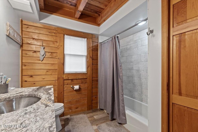 full bathroom with vanity, wood walls, wooden ceiling, toilet, and shower / bathtub combination with curtain