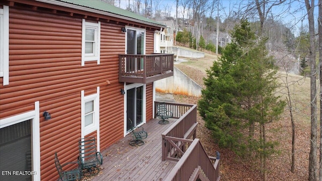 view of side of home featuring a wooden deck