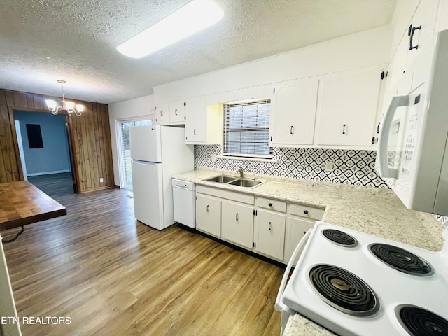 kitchen featuring decorative light fixtures, white appliances, white cabinetry, and a textured ceiling