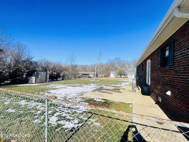 view of yard featuring a shed and a patio