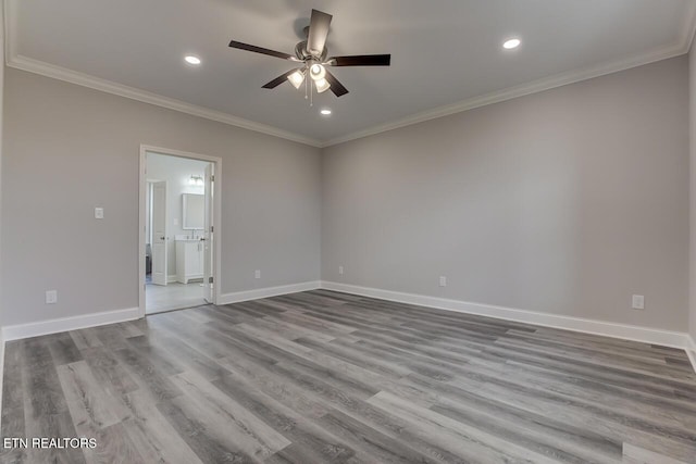 unfurnished room with ceiling fan, light wood-type flooring, and ornamental molding