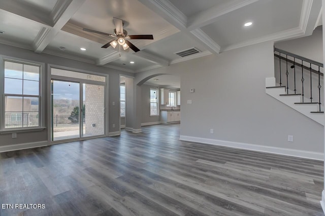 unfurnished living room with beam ceiling, dark hardwood / wood-style floors, coffered ceiling, and ornamental molding