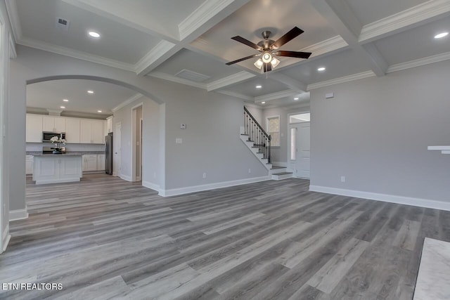 unfurnished living room featuring beamed ceiling, light hardwood / wood-style floors, and coffered ceiling