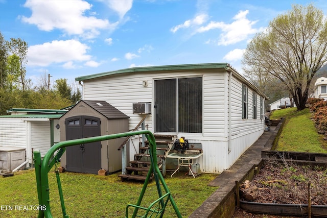 rear view of house featuring a storage unit and a lawn