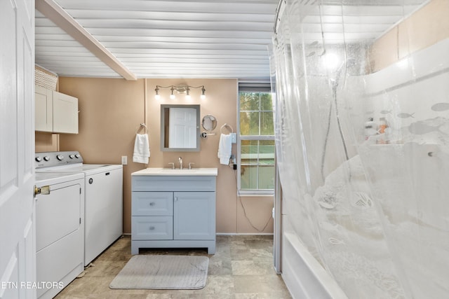 bathroom featuring washer and dryer, shower / tub combination, and vanity