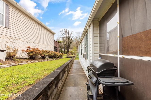 view of side of home with a yard