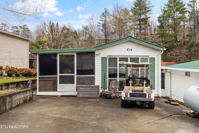 back of house featuring a sunroom