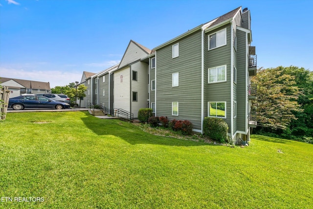 view of side of property featuring a yard